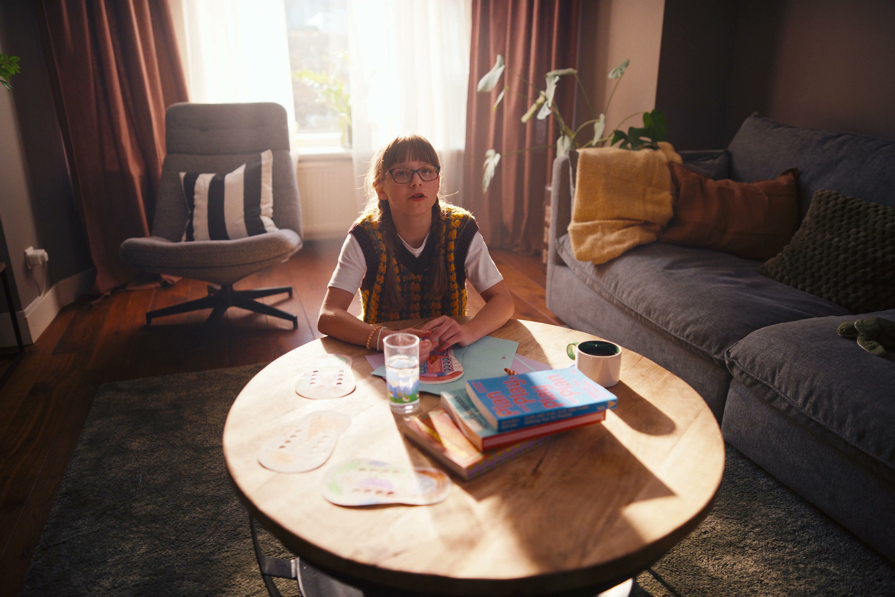 Girl learning about money at a living-room table in the ABN AMRO and Gimi campaign